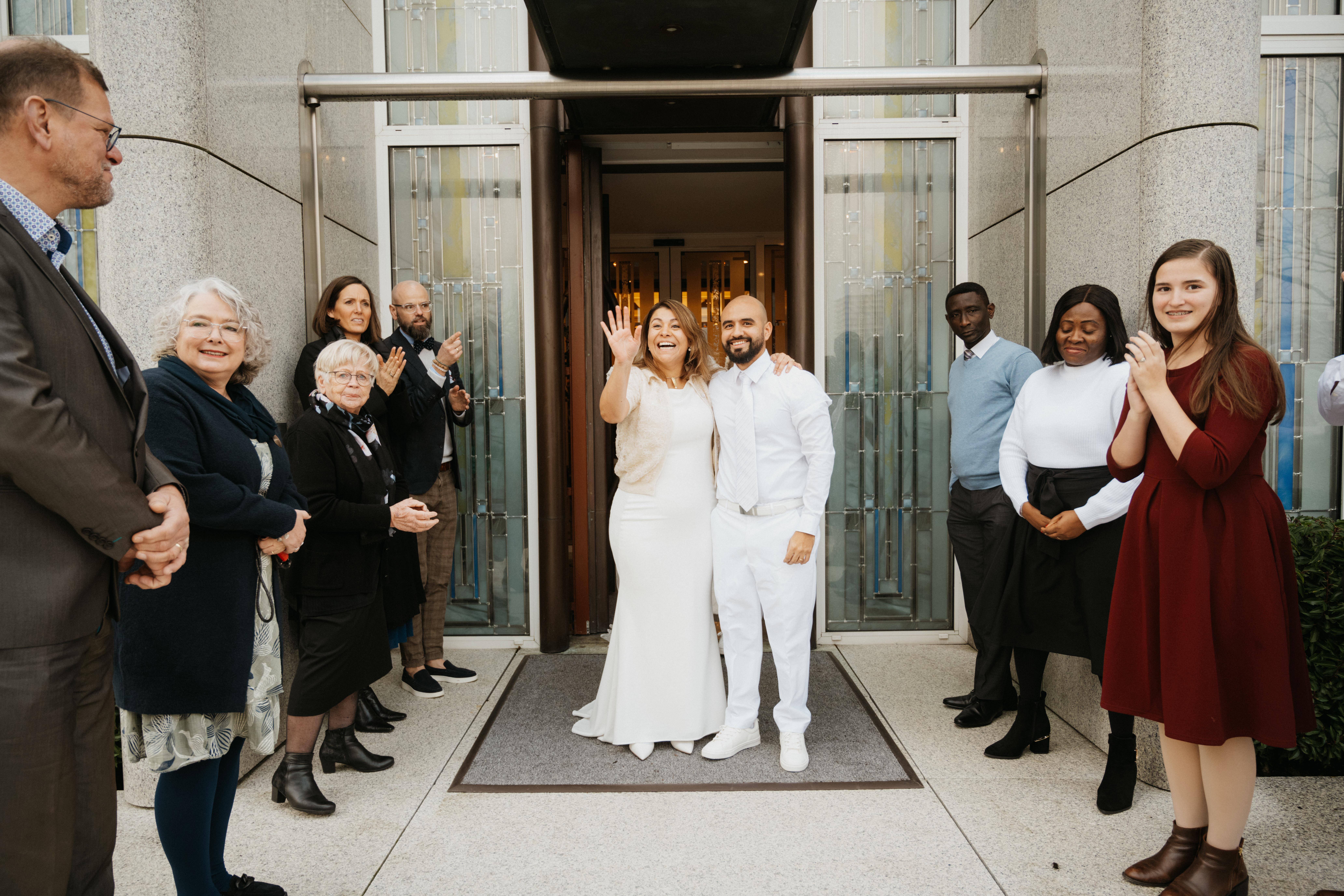 A bride and groom exit the Hague Netherlands temple after their sealing ceremony